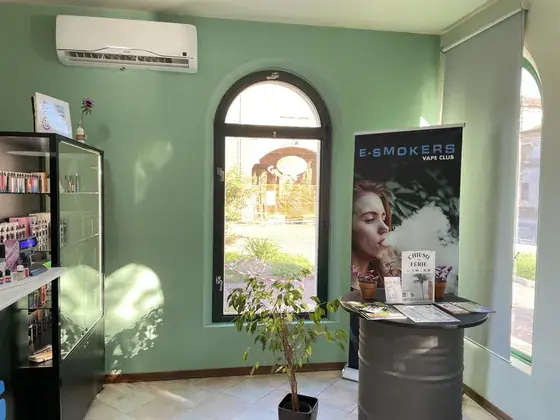 Angolo interno del negozio E-smokers Bevilacqua con finestra ad arco e totem promozionale - negozio sigarette elettroniche Bevilacqua